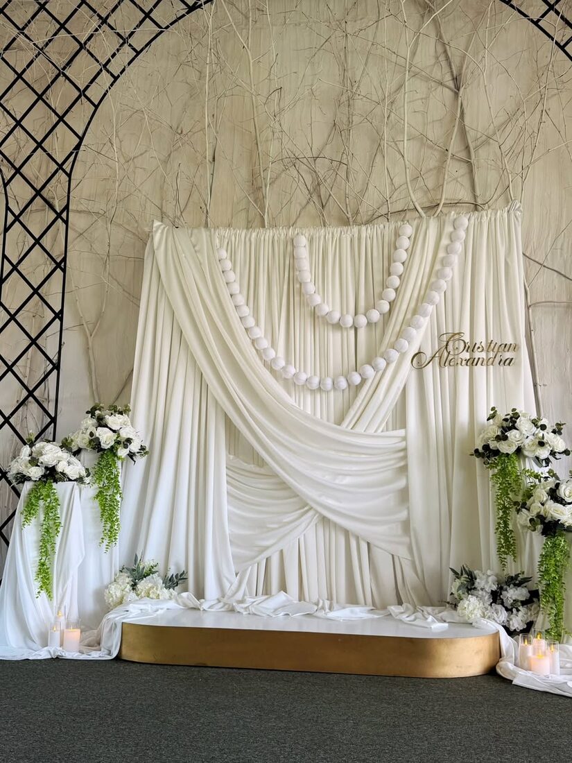 Photocorner de nuntă cu draperii ivory și ghirlande de perle